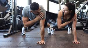 Sculpting Sleek Arms: The Essential Role of Cardio in Toning Without Bulking Up 1 Image of man and woman doing Cardio Leeds to tone their arms.